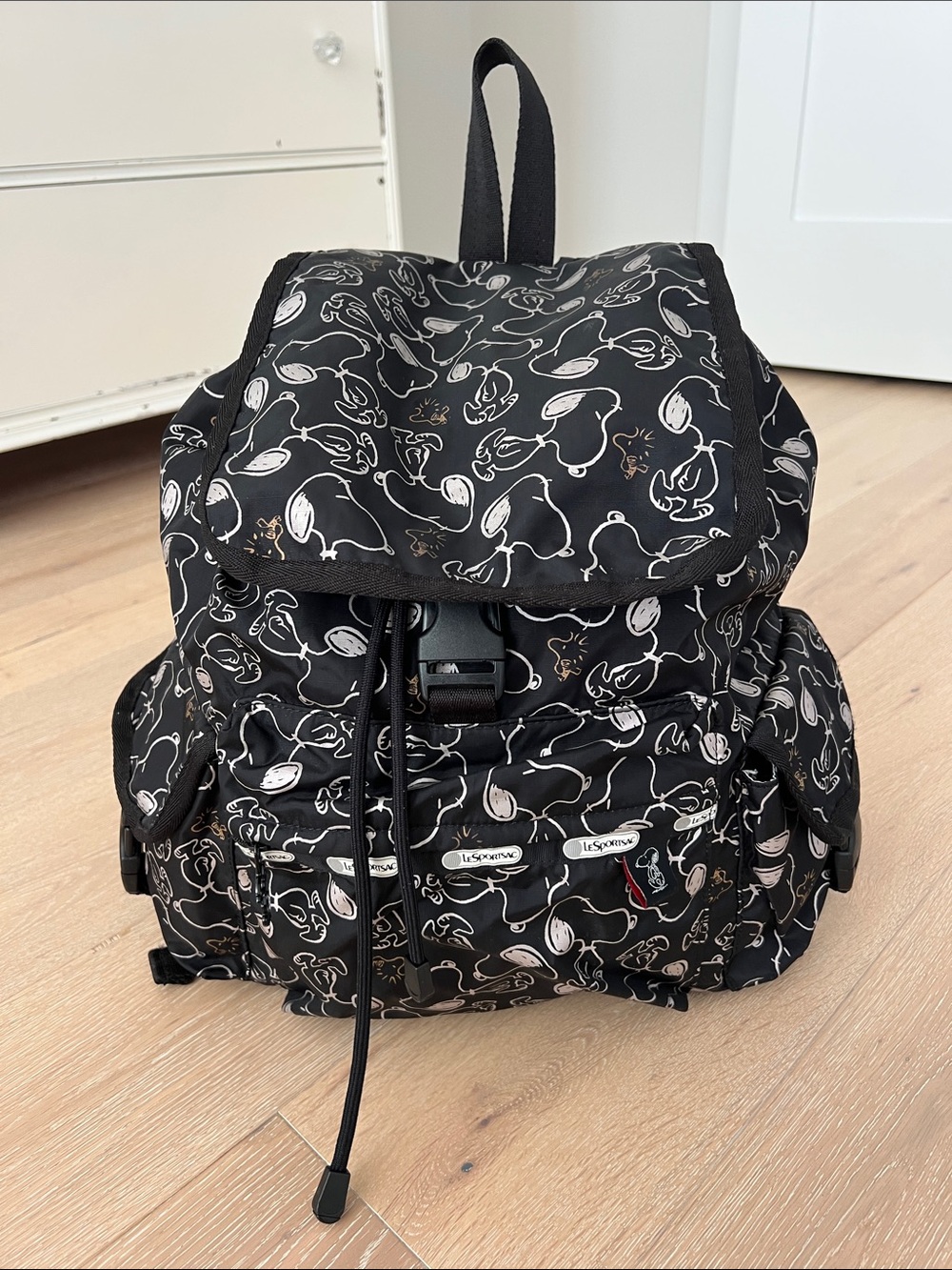 Lesportsac Peanuts Snoopy Black Backpack with White and Gold Printed Pattern